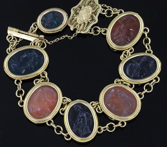 A late Victorian style gold and Intaglio hardstone bracelet, with filigree clasp and safety chain, gross 48.9 grams.